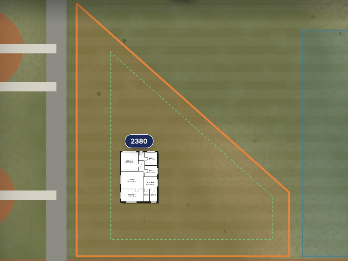 A satellite view of Lot 22 outlined in orange, with a black-and-white floor plan placed inside dashed setback lines